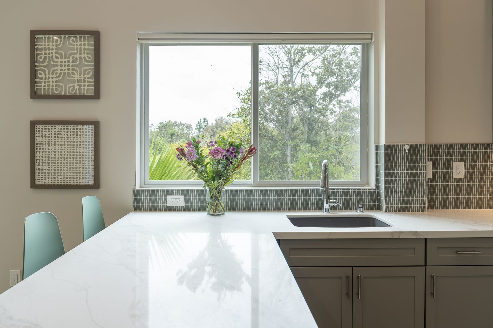 Rancho Bernardo ADU kitchen with soft gray shaker cabinets, a quartz peninsula and a window over the sink