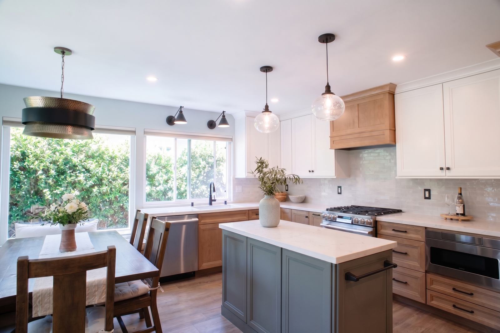 Mira Mesa kitchen with a green island, maple cabinetry and white uppers beside a banquette