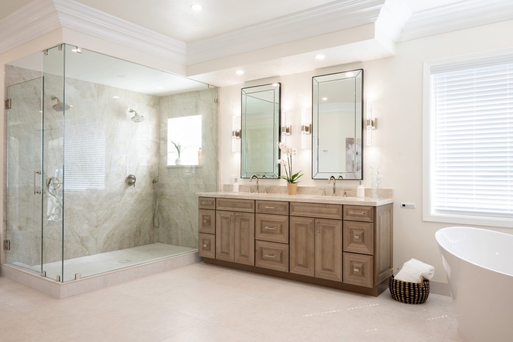 Bright daylight view of Taj Mahal quartzite shower and double vanity with polished-nickel fixtures