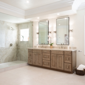 Bright daylight view of Taj Mahal quartzite shower and double vanity with polished-nickel fixtures