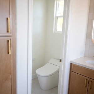 Compact water-saving smart toilet in private enclosure.
