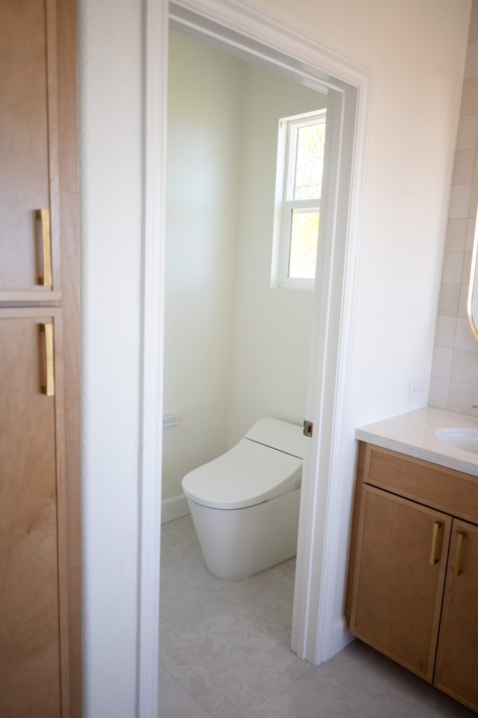 Compact water-saving smart toilet in private enclosure.