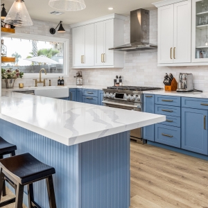 Blue-white kitchen featuring large quartz island