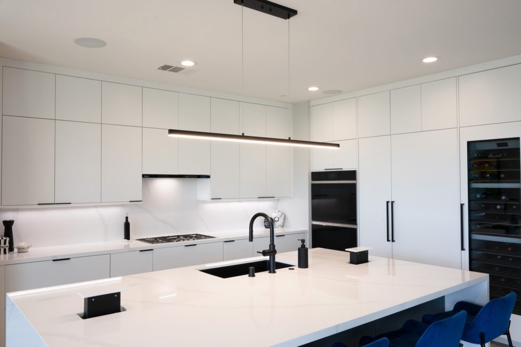 Modern kitchen island with pop-up outlets near the sink
