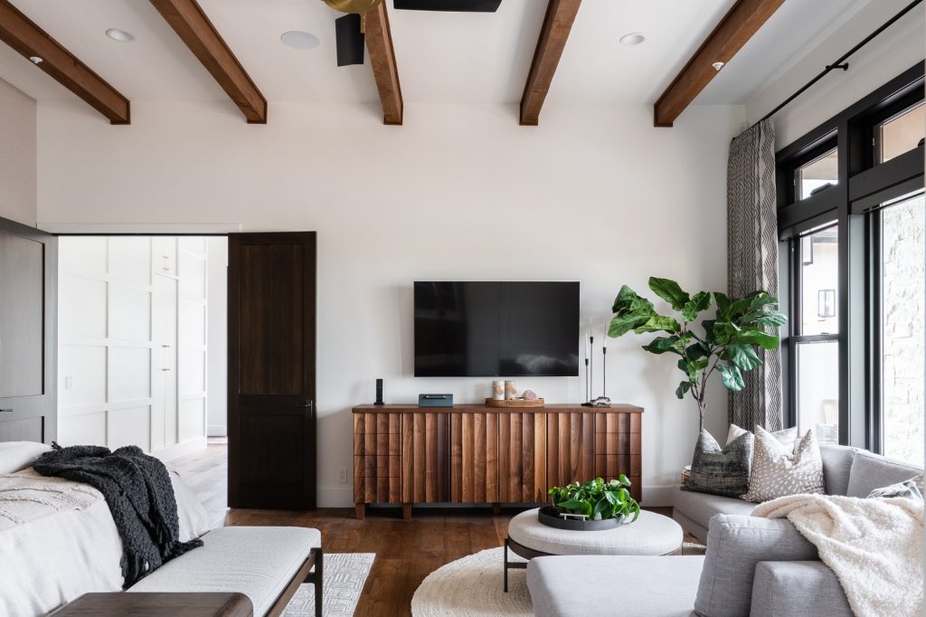 Living room with exposed wood ceiling beams as a design feature, 2025 Design Trend