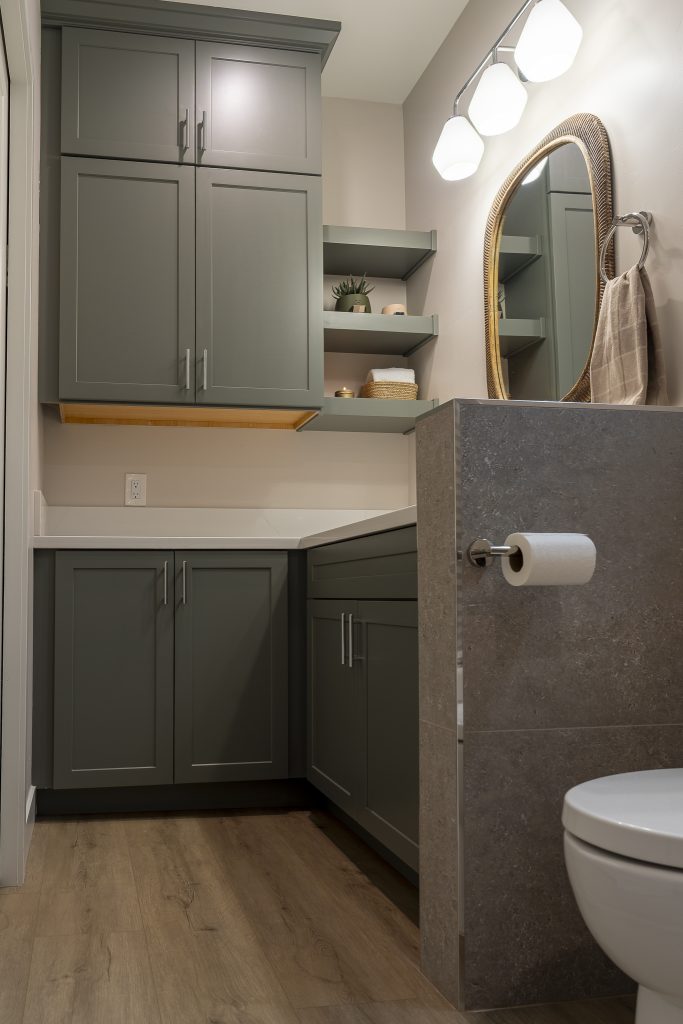 Tall linen cabinets with floating shelves in ADU bath