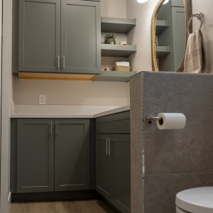 Tall linen cabinets with floating shelves in ADU bath