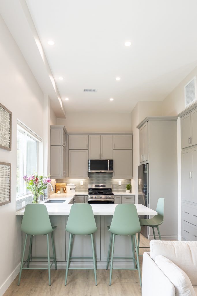 ADU kitchen with peninsula seating and recessed lighting