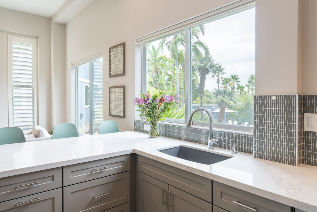 Undermount Silgranit sink below window and tile splash