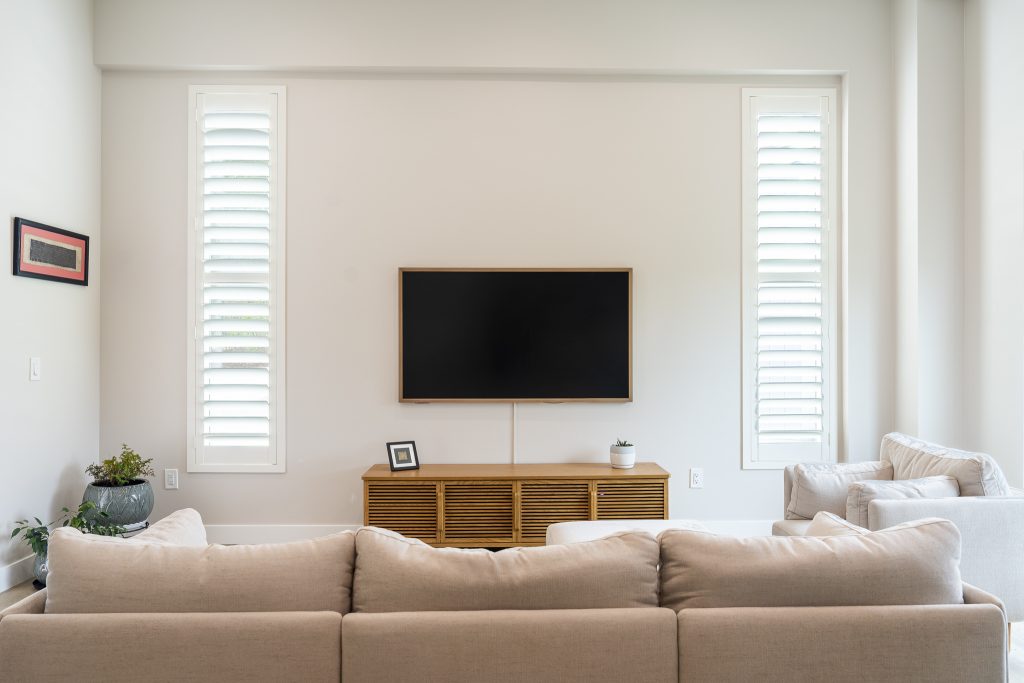 Open living to kitchen with mint stools and big windows