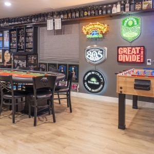 Neon brewery wall with foosball and poker table