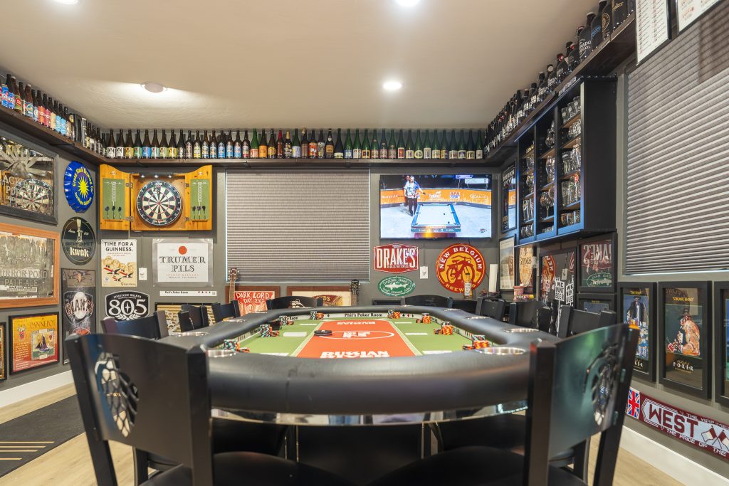 Poker table zone with dartboard cabinet and TV