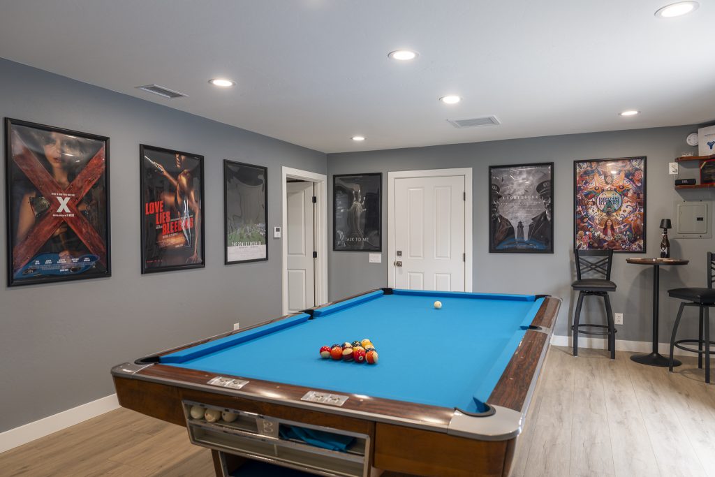 Game room pool table and gallery wall of posters