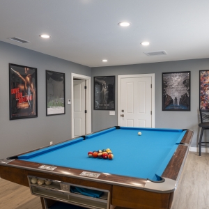 Game room pool table and gallery wall of posters