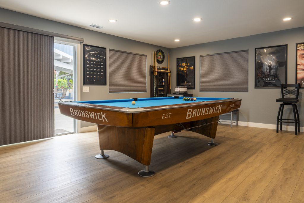 Pool table with sliders to patio and cue rack corner