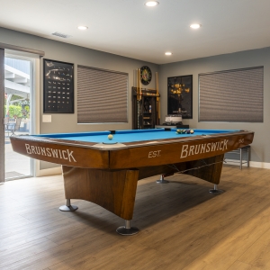 Pool table with sliders to patio and cue rack corner