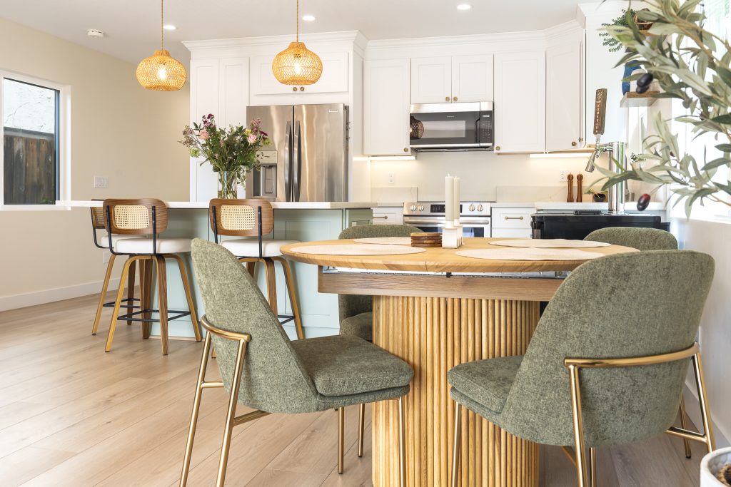 Dining nook beside white Shaker kitchen with quartz counters
