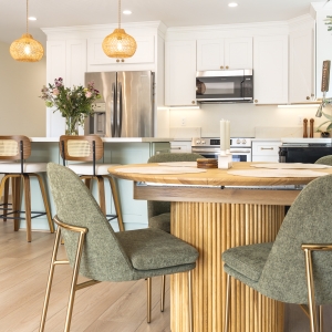 Dining nook beside white Shaker kitchen with quartz counters