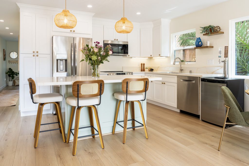 Island overhang with cane stools and warm brass accents