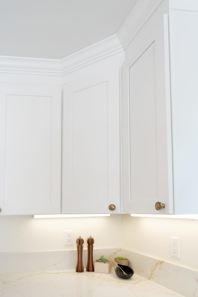 Corner uppers with under-cabinet LEDs and quartz backsplash