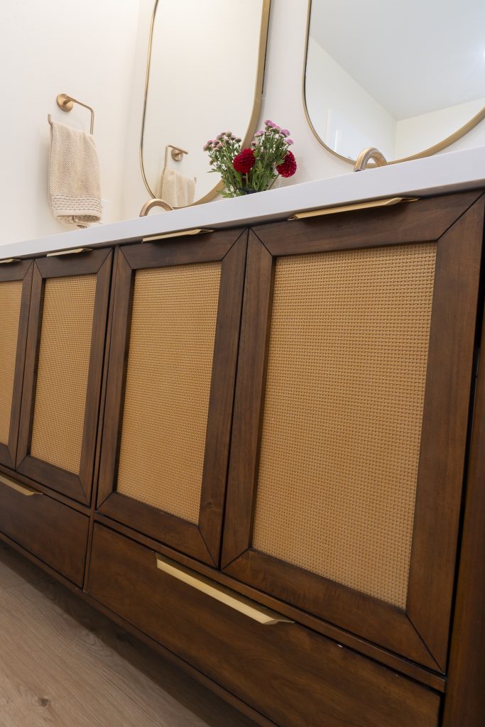 Glass shower with brass rail and white subway tile surround