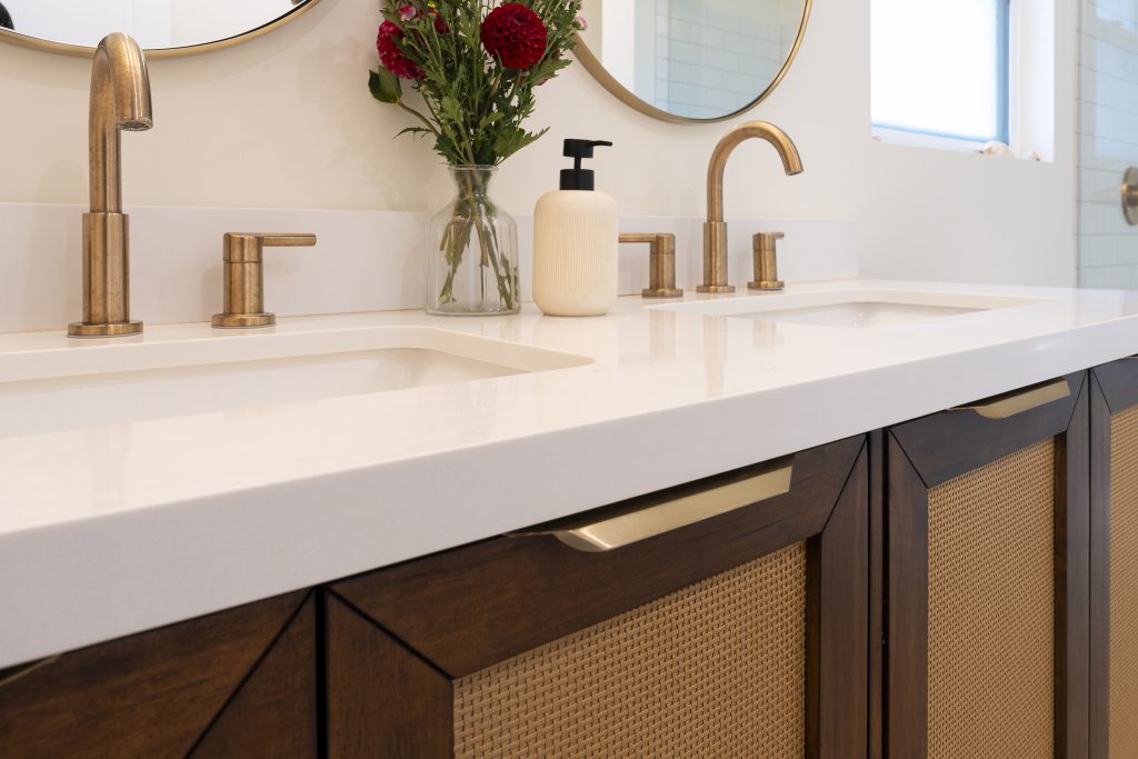 Quartz vanity top with champagne-bronze widespread faucets