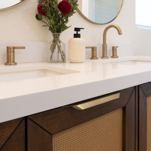 Quartz vanity top with champagne-bronze widespread faucets