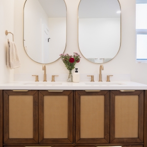 Woven-front vanity doors with brass finger pulls