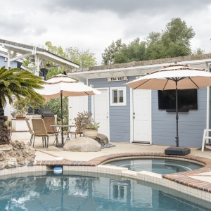 Poolside view toward Tiki Hut with umbrellas and spa