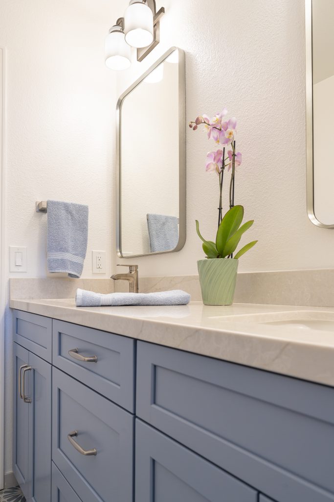 Blue Shaker vanity with MSI Lumatáj quartz and rounded-corner framed mirrors