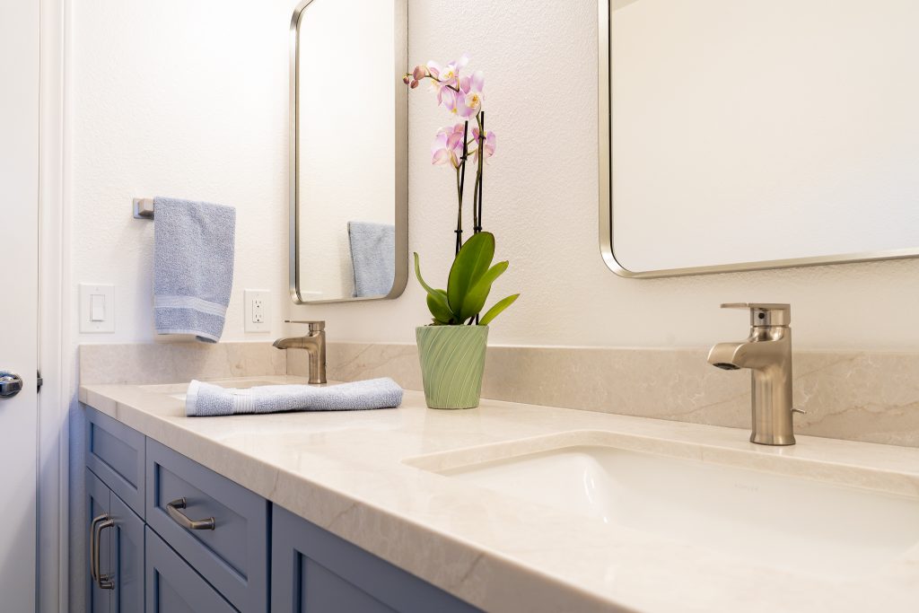Double vanity with Kohler faucets and a quartz countertop