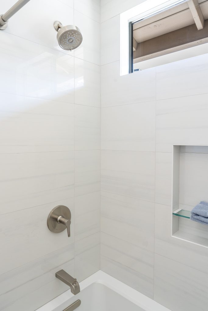 Kohler shower trim and tub spout over the Archer tub with large white wall tile