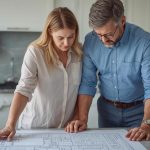 San Diego homeowners reviewing remodel change order plans in the kitchen
