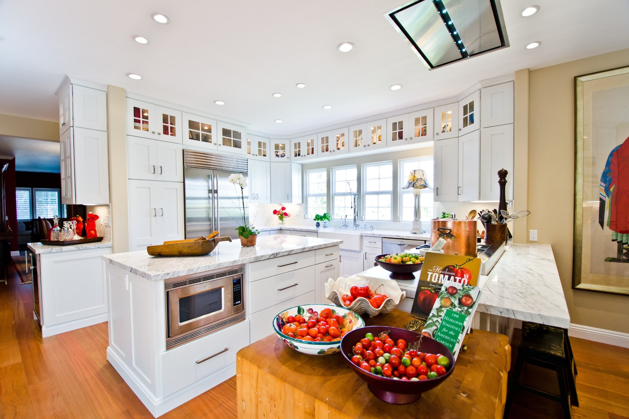 Timeless white kitchen remodel in San Diego with warm wood floors and classic cabinetry by Kaminskiy Design and Remodeling