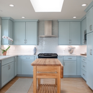 Wide view of Point Loma kitchen remodel with custom blue cabinetry, quartz counters, and stainless appliances