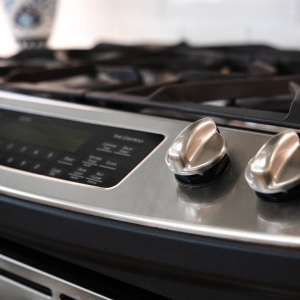 Close-up of stainless range knobs and cooktop detail in remodeled kitchen