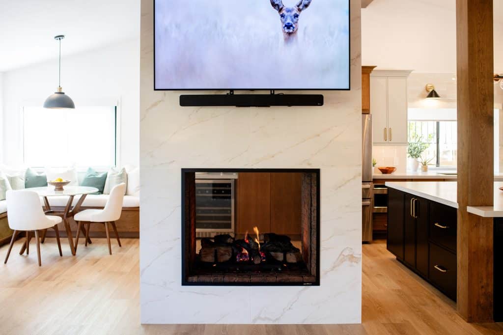 Double-sided fireplace between the kitchen and nook