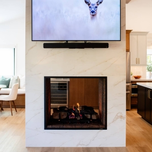 Double-sided fireplace between the kitchen and nook