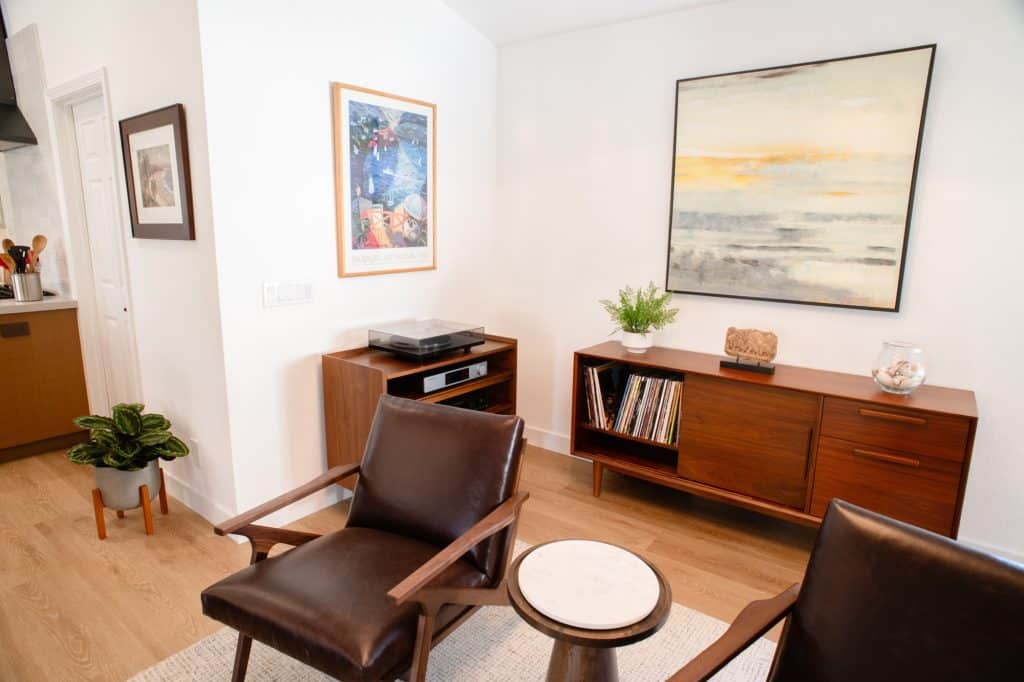 Family room with leather chairs and walnut media console