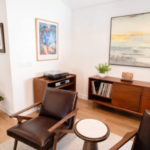 Family room with leather chairs and walnut media console