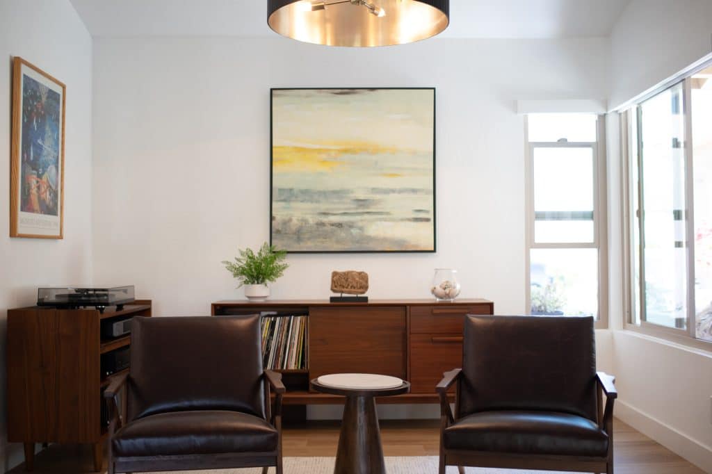 Seating area with leather chairs and media cabinet