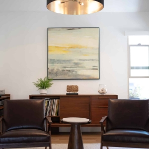 Seating area with leather chairs and media cabinet