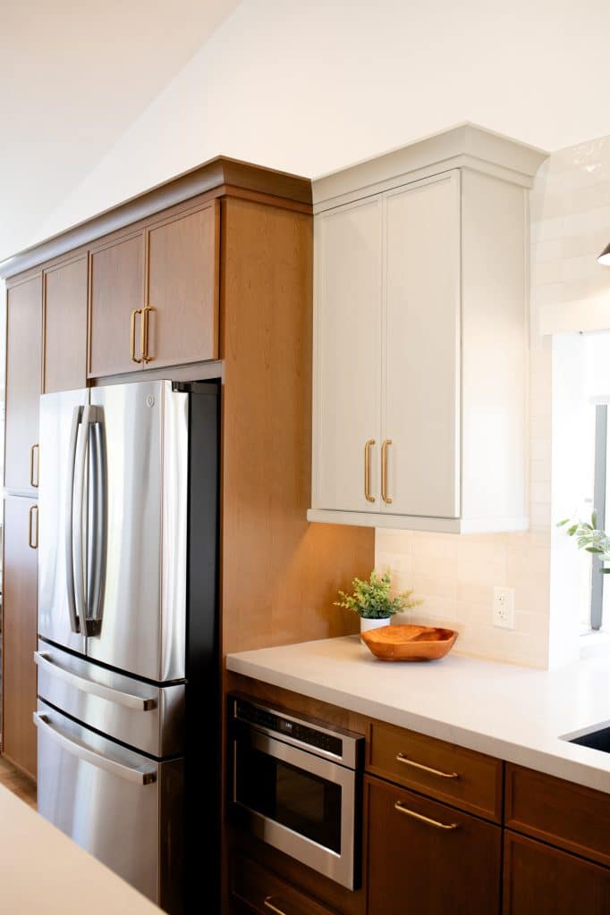 Refrigerator, microwave drawer, and surrounding cabinetry
