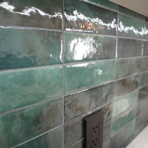 Close-up of the green ceramic backsplash tile