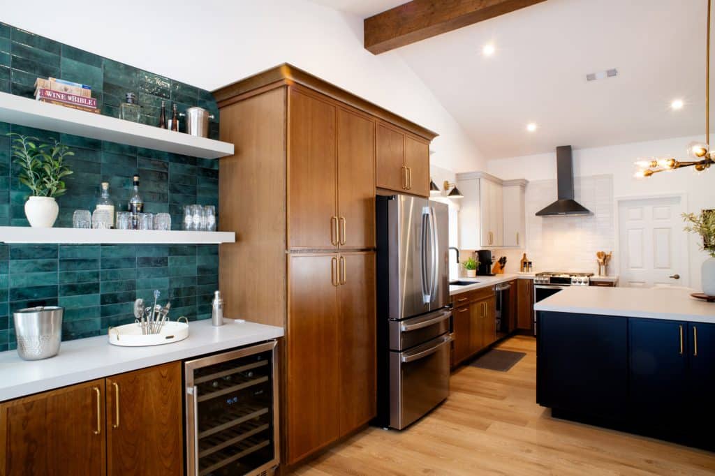 Kitchen with tall cabinetry, beverage station, and island