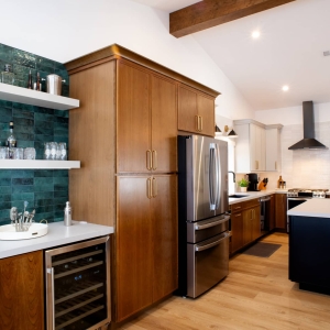Kitchen with tall cabinetry, beverage station, and island