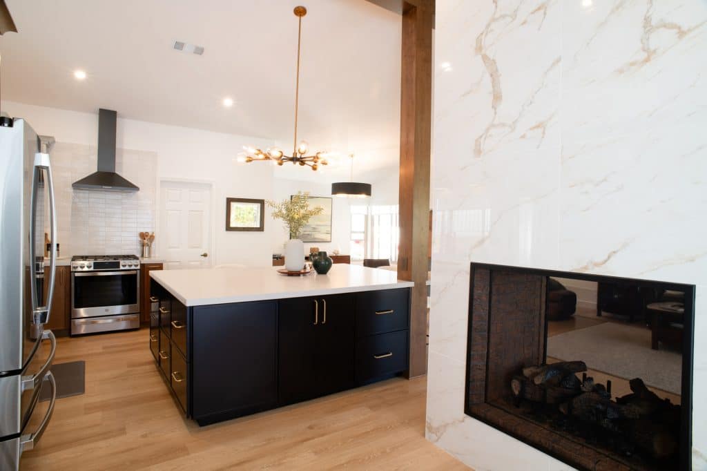 Double-sided fireplace beside the kitchen island