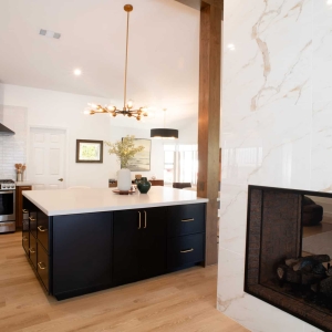 Double-sided fireplace beside the kitchen island
