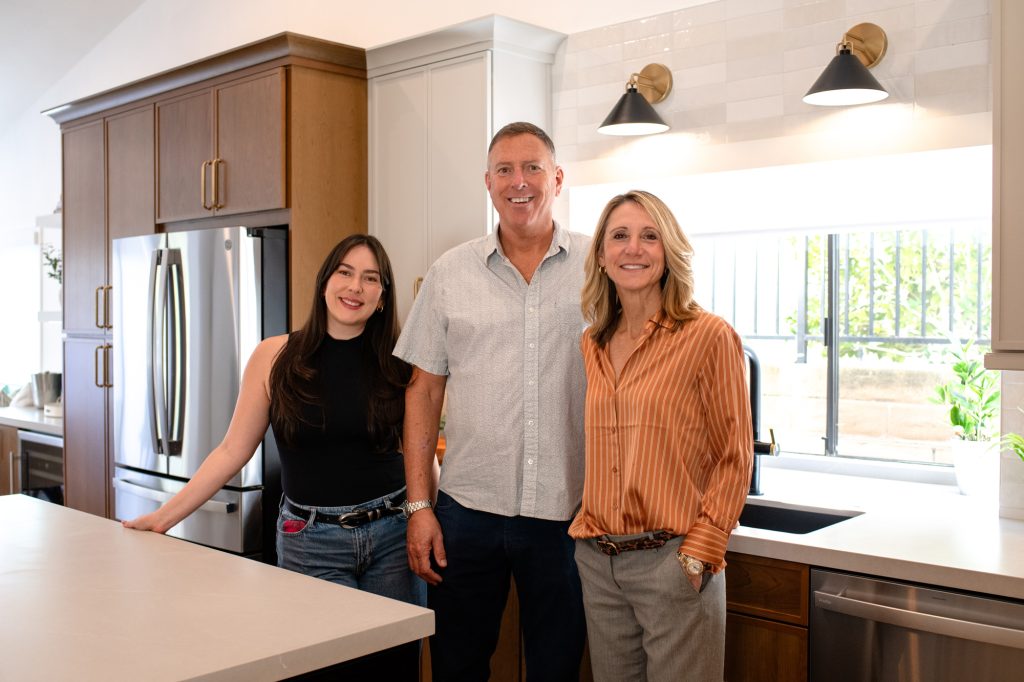 Designers and client group photo in the completed kitchen remodel