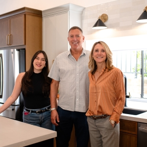 Designers and client group photo in the completed kitchen remodel